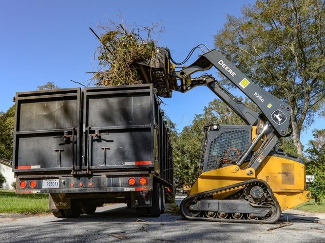 tgolandandseptic-storm-debris-being-loaded-into-hauling-truck
